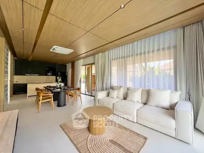 Spacious modern living room with open kitchen, featuring elegant wood finishes and large windows.