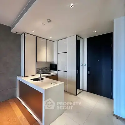 Modern kitchen with sleek cabinetry and integrated appliances in a luxury apartment.