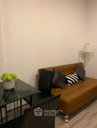 Modern living room with stylish brown sofa and sleek black dining set