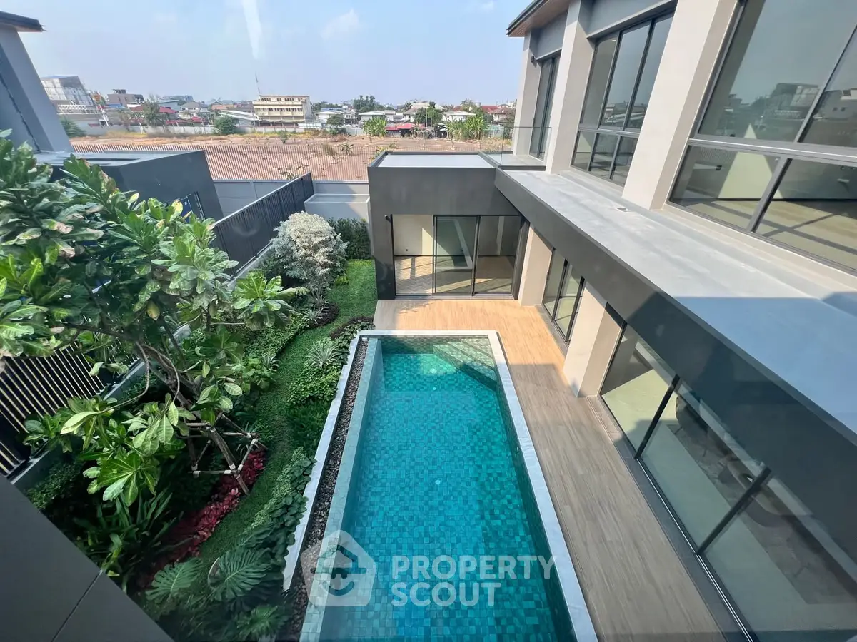 Luxurious modern home with private pool and lush garden view, perfect for relaxation and entertaining.