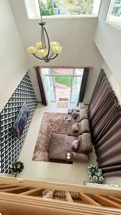 Stunning two-story living room with large windows and elegant decor