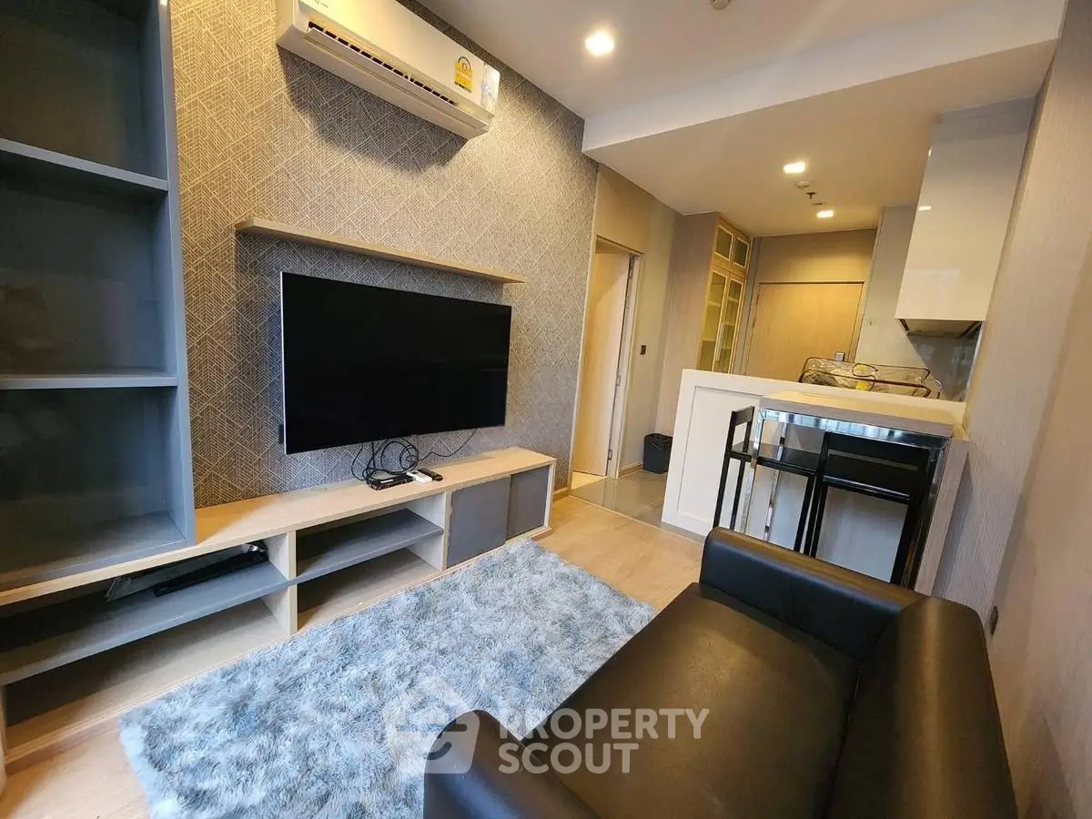 Modern living room with sleek furniture and open kitchen layout