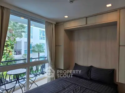 Cozy bedroom with balcony view in modern apartment