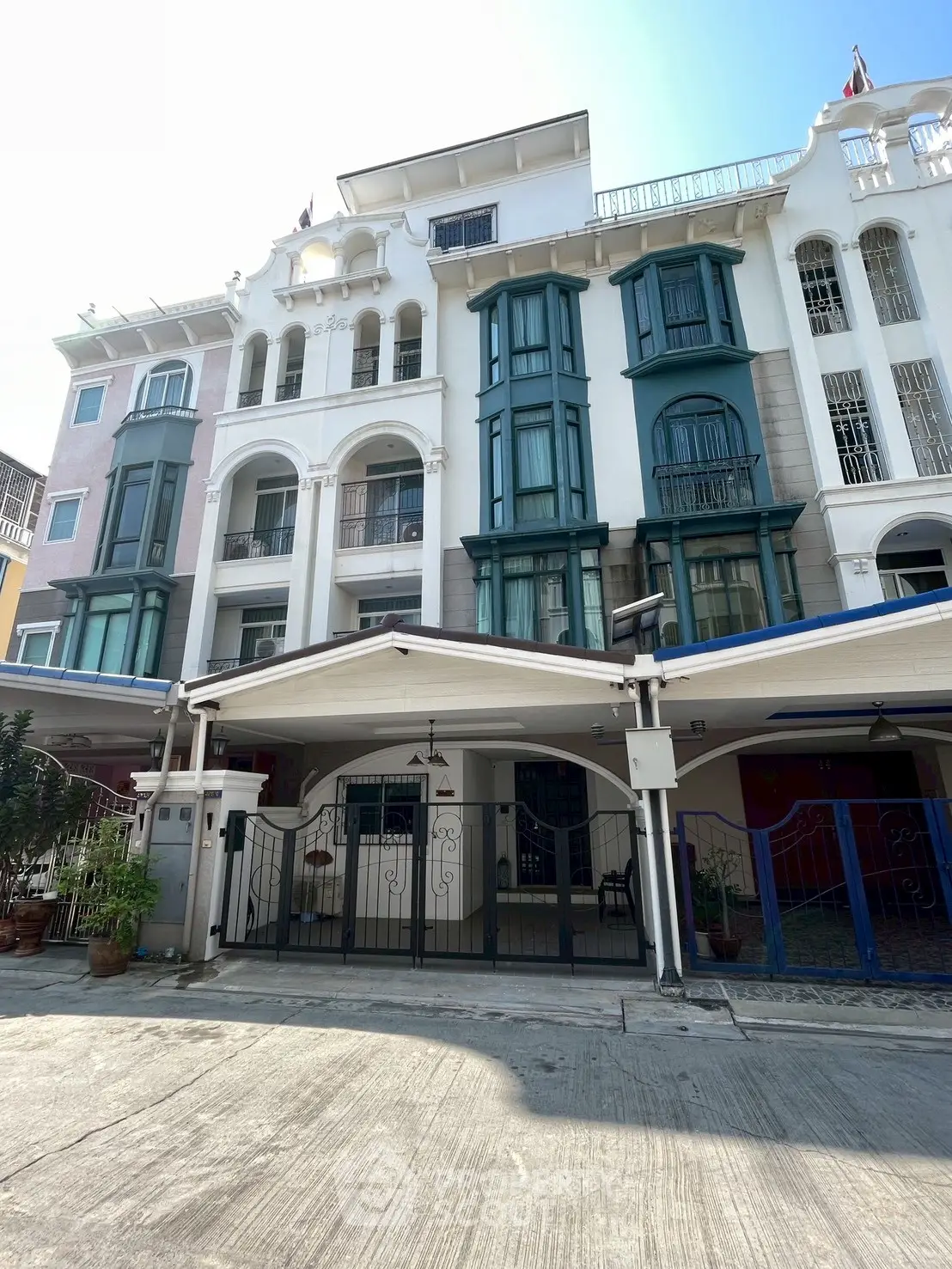 Charming multi-story townhouse with unique architectural design and spacious balconies.