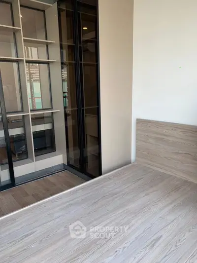 Modern bedroom with wooden flooring and built-in shelving unit