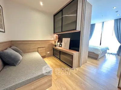 Modern apartment interior with cozy living area and bedroom, featuring stylish wood flooring and elegant decor.