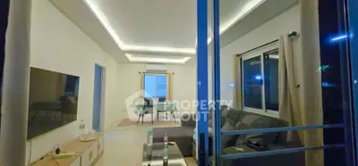 Spacious modern living room with cozy seating and ambient lighting