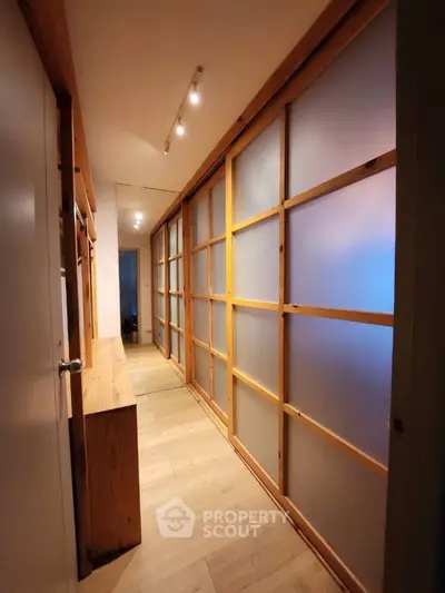 Elegant hallway with wooden accents and frosted glass panels
