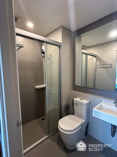 Modern bathroom with glass shower enclosure and sleek fixtures