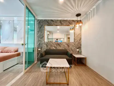 Modern living room with marble accents and stylish lighting in a contemporary apartment.