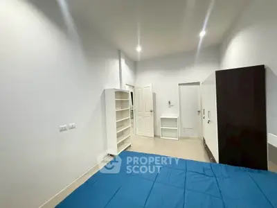 Spacious bedroom with modern furnishings and ample storage space.