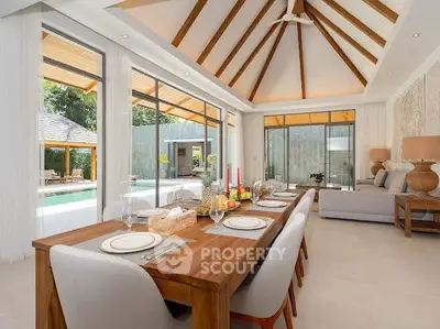 Luxurious open-plan living room with pool view and elegant dining area in modern villa.
