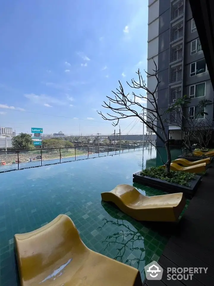 Luxurious apartment poolside with modern loungers and stunning city view.