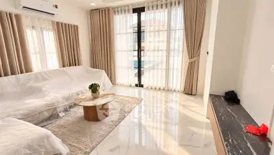 Spacious living room with elegant curtains and modern decor