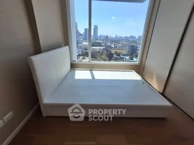 Modern bedroom with city view and sleek white bed frame