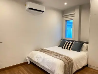Cozy bedroom with modern air conditioning and stylish decor