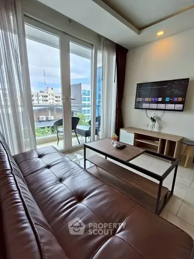 Modern living room with leather sofa and balcony view in urban apartment