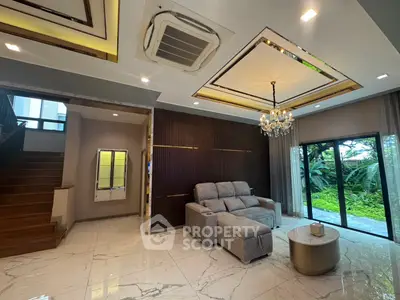 Luxurious living room with elegant chandelier and garden view