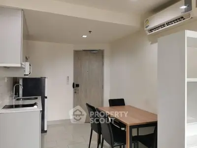 Modern kitchen and dining area with sleek appliances and minimalist design
