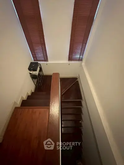 Elegant wooden staircase with natural light and modern design