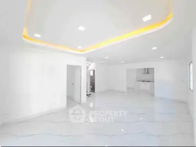Spacious modern living room with elegant ceiling lights and glossy marble flooring