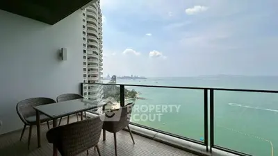 Stunning ocean view from modern balcony with stylish outdoor seating