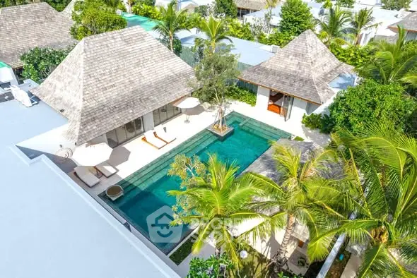 Luxurious tropical villa with private pool and lush greenery, perfect for serene living.