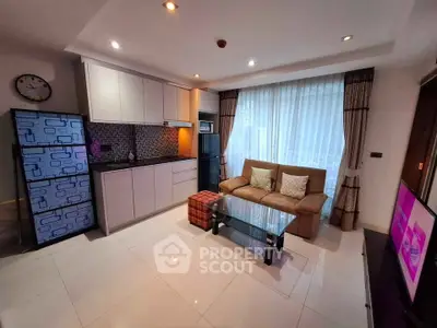 Modern living room with sleek kitchen, cozy sofa, and stylish decor in a bright apartment.