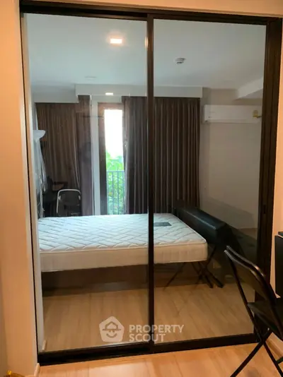 Modern bedroom with glass sliding doors and balcony view