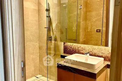 Luxurious bathroom with modern shower and elegant sink in a high-end property.