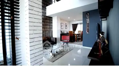 Modern living room with stylish decor and open layout, featuring sleek furniture and elegant design.