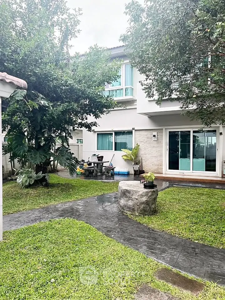 Charming suburban home with lush garden and patio, perfect for outdoor relaxation.