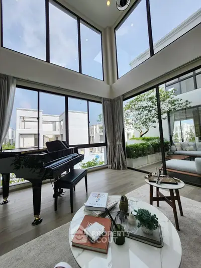Luxurious living room with grand piano and floor-to-ceiling windows offering stunning views.