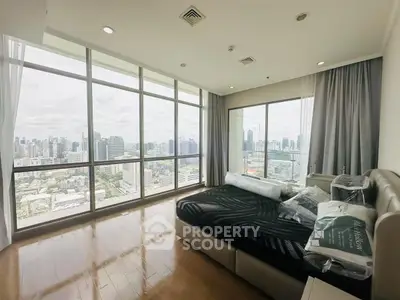 Luxurious bedroom with panoramic city view and floor-to-ceiling windows