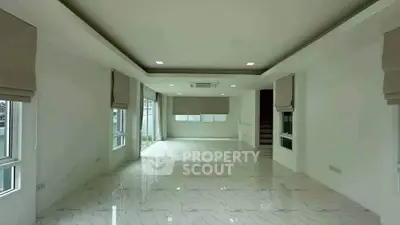 Spacious modern living room with marble flooring and large windows