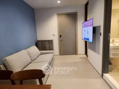 Modern living room with cozy sofa and wall-mounted TV, ideal for relaxation.