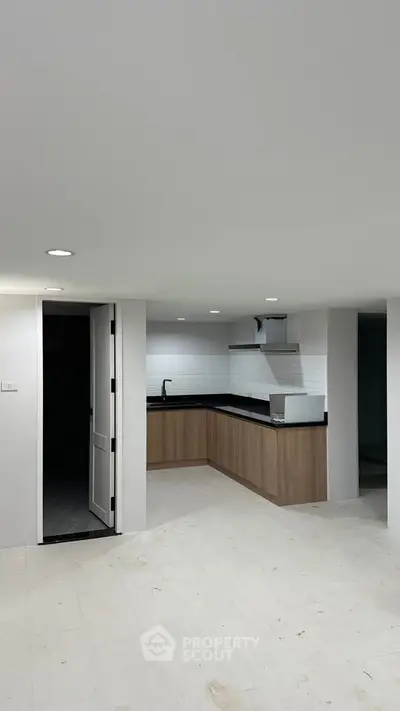 Modern kitchen with sleek cabinetry and open layout in a contemporary apartment.