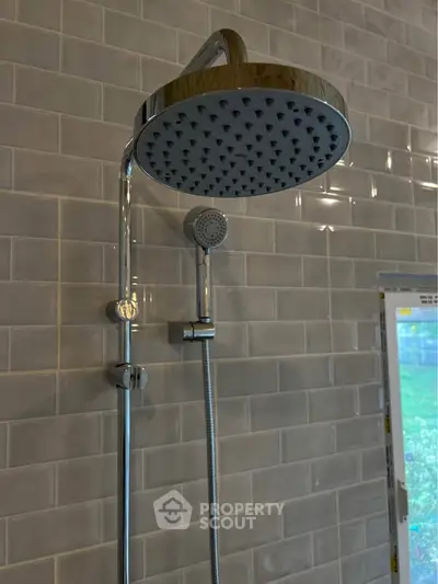 Modern bathroom shower with sleek chrome fixtures and subway tile wall