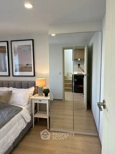 Modern bedroom with mirrored closet and cozy decor