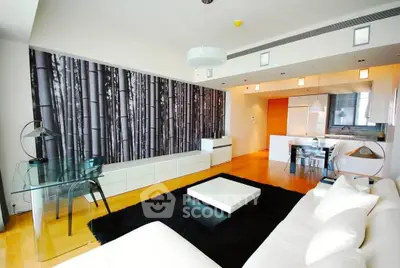 Modern living room with open kitchen, stylish decor, and sleek furniture in a contemporary apartment.