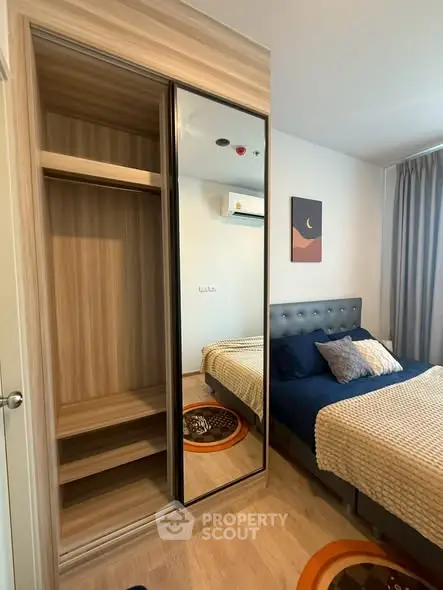Modern bedroom with stylish decor and mirrored wardrobe