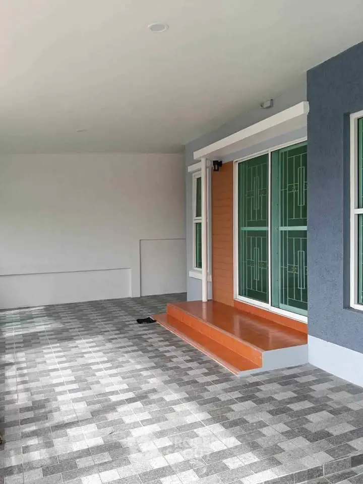 Modern home entrance with stylish tiled flooring and sleek glass doors