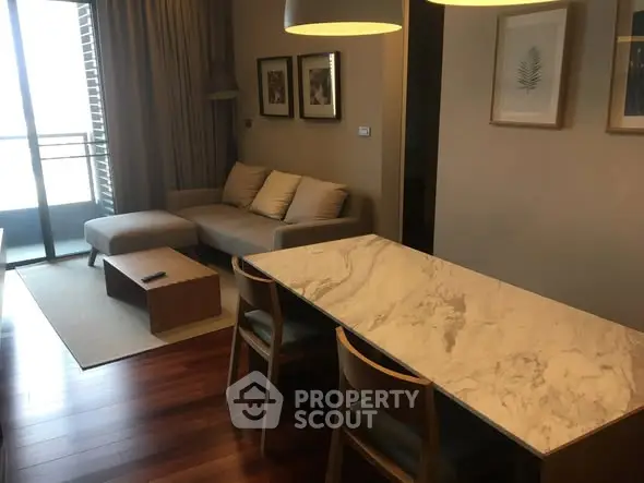 Modern living room with elegant dining area and balcony view