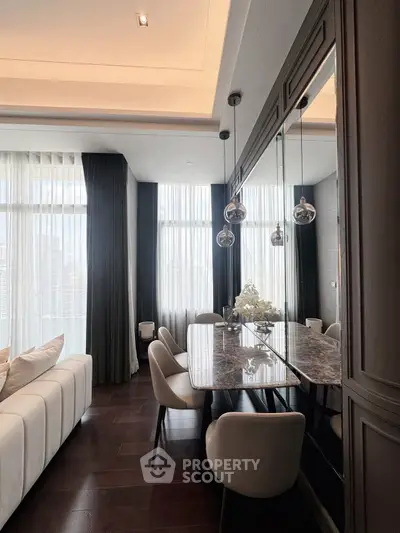 Luxurious dining area with elegant decor and floor-to-ceiling windows in modern apartment.