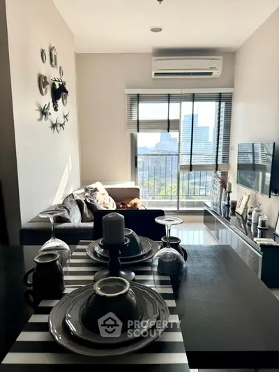 Modern living room with city view, stylish decor, and dining setup.