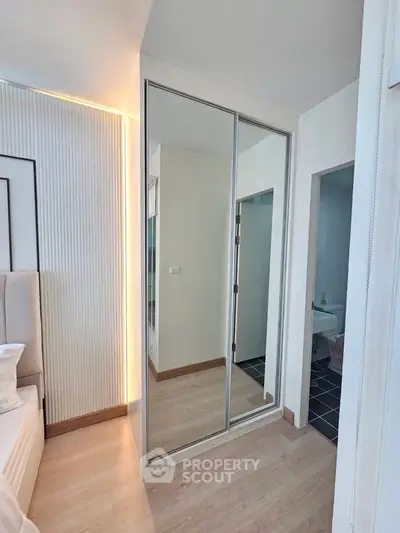 Modern bedroom with mirrored closet and sleek design