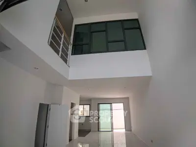 Spacious modern living room with high ceiling and large windows