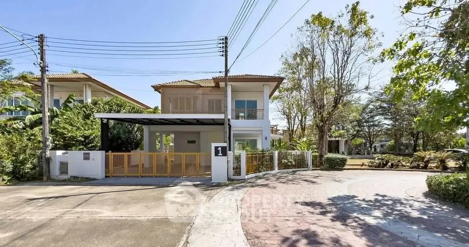 Charming two-story house with spacious driveway and lush greenery in a serene neighborhood.
