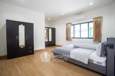 Spacious bedroom with modern furniture and natural light
