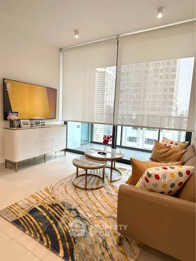 Modern living room with stylish decor and city view, featuring a cozy sofa and elegant coffee table.